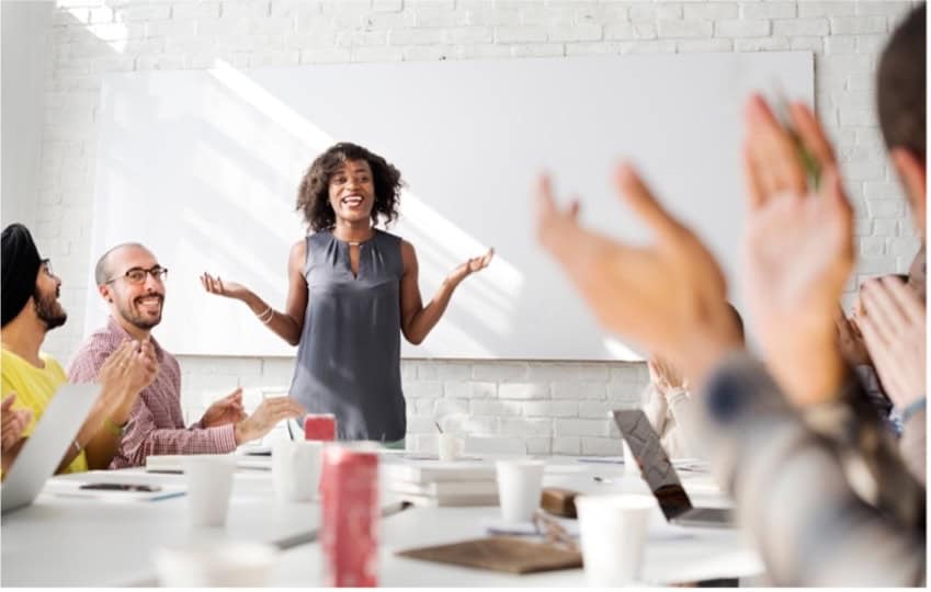 Facilitator building trust with a diverse group in a collaborative meeting setting.