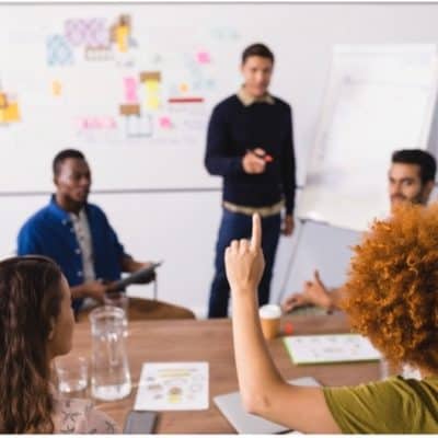 Facilitator managing a challenging meeting with participants expressing differing opinions.