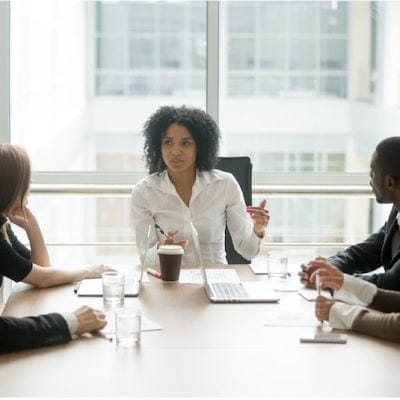 Team engaged in a structured meeting discussion designed to keep meetings on track and support clear outcomes.